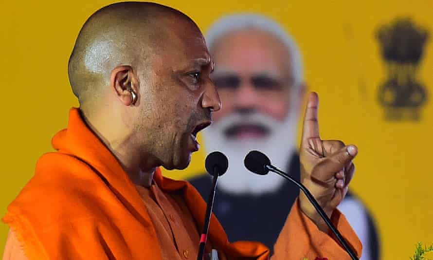 Le ministre en chef de l'Uttar Pradesh Yogi Adityanath s'adresse à un rassemblement public, devant une image du premier ministre, Narendra Modi